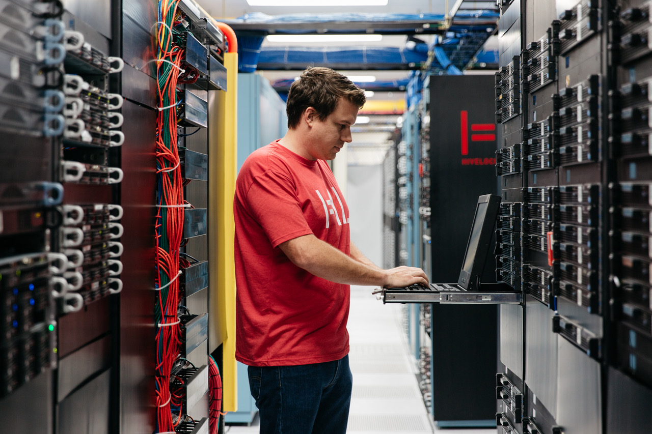 A Hivelocity employee standing among racks of servers