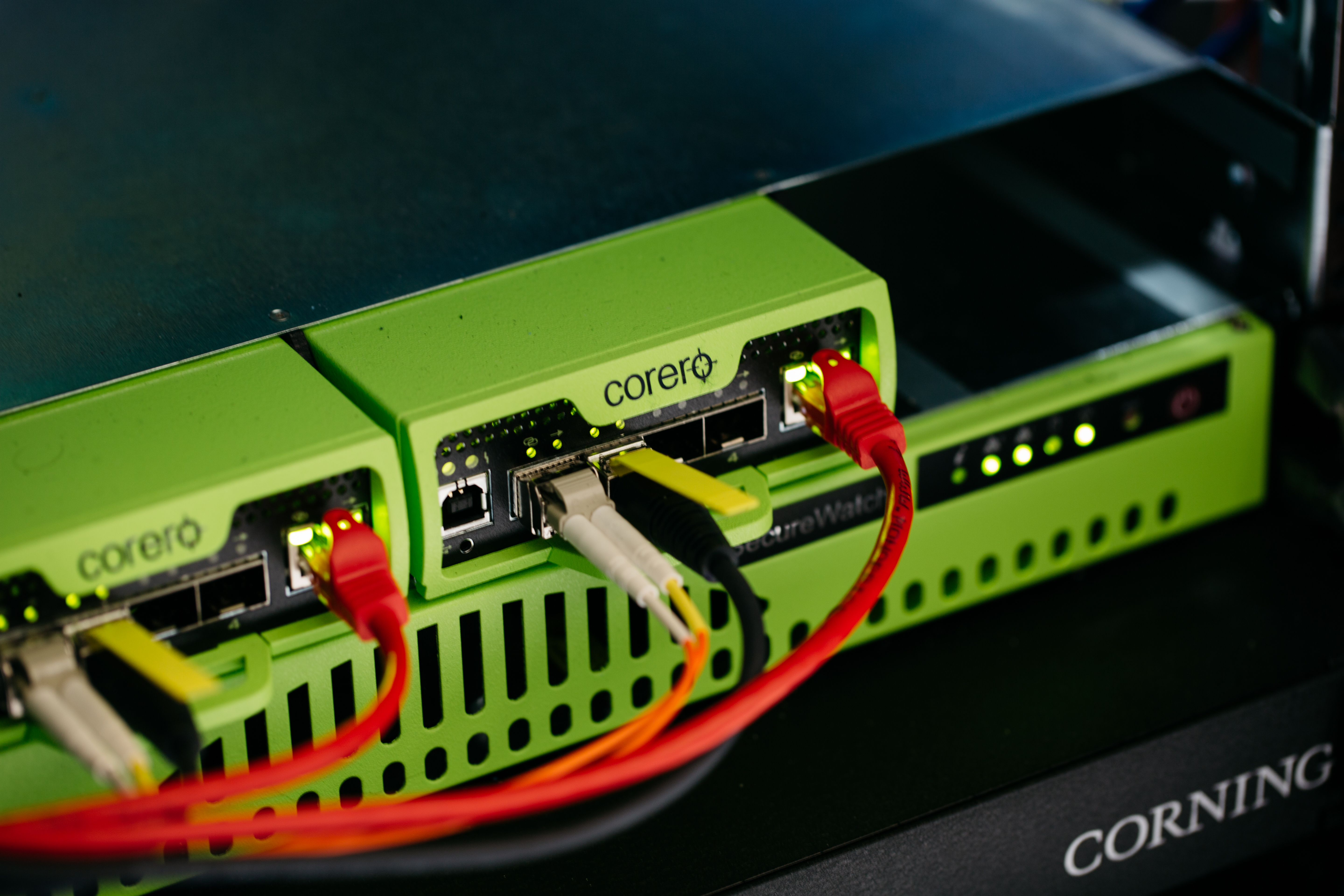 Ethernet cords running into the back of a Corero firewall