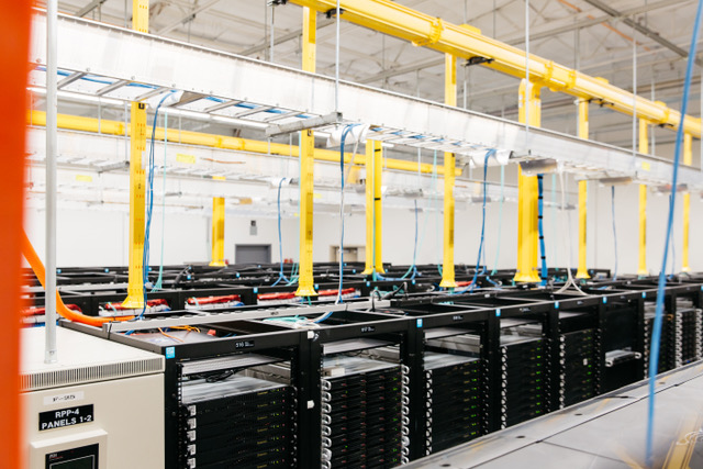 The inside of a Hivelocity data center, showing rows of server cabinets
