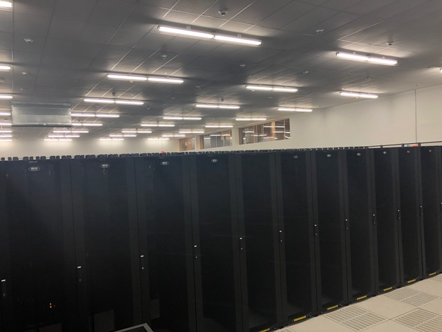 A room filled with rows of server cabinets