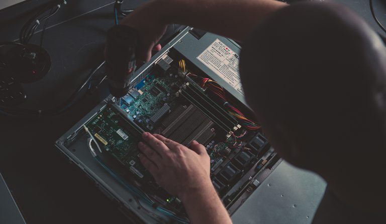 Image of a man building a server