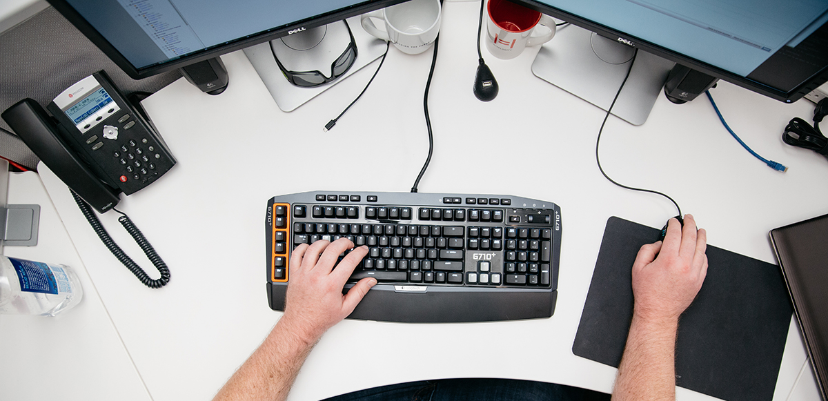 a pair of hands working a mouse and keyboard