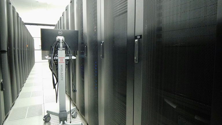 Image of Dallas datacenter racks with height-adjustable computer cart