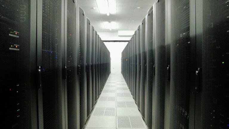 Image of Dallas datacenter between two rows with racks