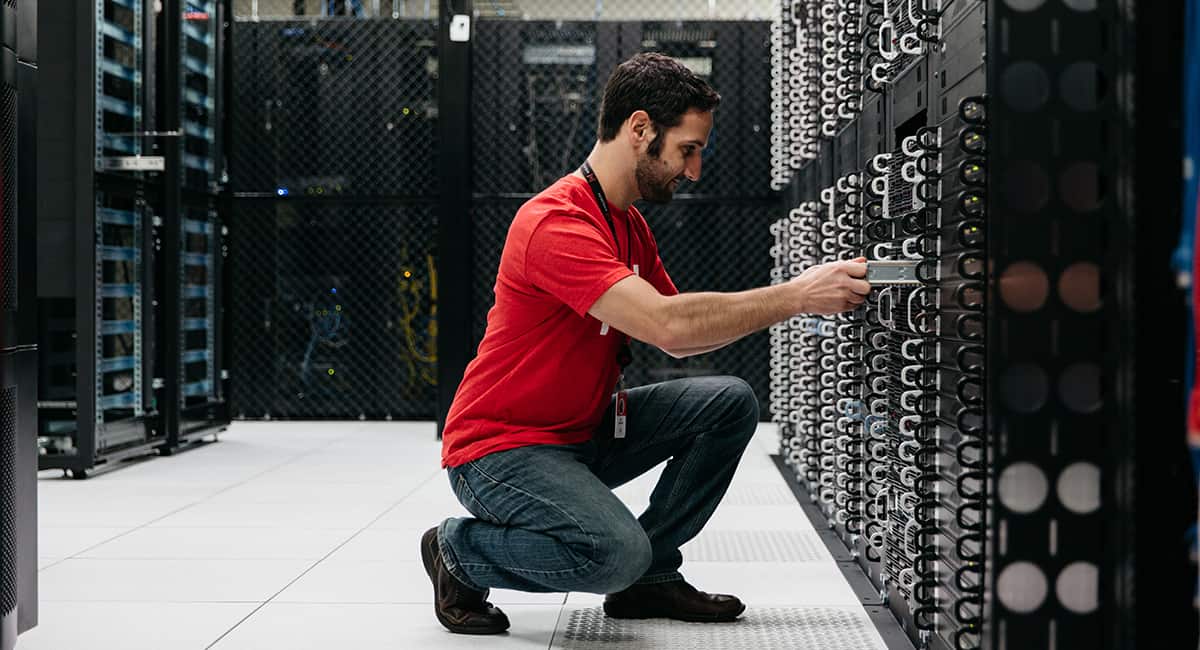 A Hivelocity employee inserting a server into a rack of servers